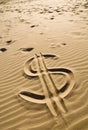 Dollar sign in the sand Royalty Free Stock Photo