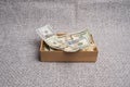 Dollar studio image. Banknotes in a small gift cardboard box Royalty Free Stock Photo