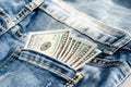 100 dollars on the back pocket jeans . Concept of prostitution or sexual exploitation