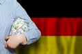 Dollars banknote and German flag background. Business, politics, banking and finance concept Royalty Free Stock Photo