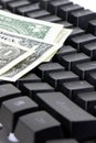 Dollars, banknotes and black keyboard isolated on a white background. Work at home. Make maoney.Select focus. Vertical Royalty Free Stock Photo