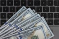 Dollars banknotes and black laptop keyboard Royalty Free Stock Photo