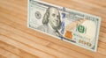 100 Dollars bill and portrait Benjamin Franklin on USA money banknote. Hundred dollar bills on wooden background Royalty Free Stock Photo