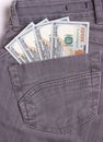 Dollars bills in black jeans back pocket.