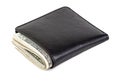 Dollars in a black leather wallet isolated on a white Royalty Free Stock Photo