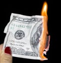 100 dollars burning on a black background