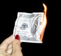 100 dollars burning on a black background