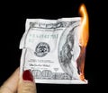 100 dollars burning on a black background