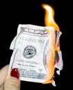 100 dollars burning on a black background