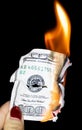 100 dollars burning on a black background