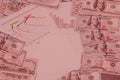 Dollars and calculations on light pink background. Royalty Free Stock Photo