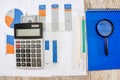 Dollars with a calculator and notepads with business charts on the table. Income analysis concept. View from above. Royalty Free Stock Photo