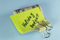 Dollars cash money in clip with text written note Holiday budget , on copy space background - concept of financial planning of set Royalty Free Stock Photo