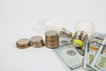 Dollars cents and two energy saving light bulbs Royalty Free Stock Photo
