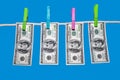 Dollars on clothespins on a rope. Royalty Free Stock Photo