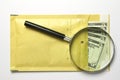 Dollars in the envelope with magnifying glass Royalty Free Stock Photo