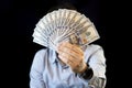 dollars in hands, male hands consider a bundle of money, concept of having money, a dark background , fan of money Royalty Free Stock Photo