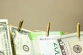 Dollars are hanging on the clothesline clothespins attached on a gold background Royalty Free Stock Photo