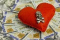 Dollars, heart, death. Concept Wedding contract, dangerous love for money, terrible Valentine`s Day. Piracy and feelings. Close-u Royalty Free Stock Photo