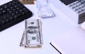 Dollars lie on the desktop in the office or Bank next to the cash register, keyboard, notebook and check. Workplace Manager Royalty Free Stock Photo