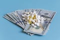 dollars pills medicine. Prescription medicine on dollars for pharmaceutical industry concept of high cost for healthcare and medic Royalty Free Stock Photo