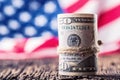 Dollars rolled banknotes closeup with american flag in the background. Cash Money American Dollars.Close-up view of stack of US do Royalty Free Stock Photo