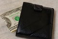 20 dollars sticking out of a wallet of dark leather on a gray background Royalty Free Stock Photo