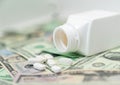 White pills on dollar money background Royalty Free Stock Photo