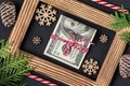 Dollars on wooden photo frame. Christmas gift Royalty Free Stock Photo