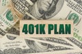 On the dollars is a wooden plate with the inscription - 401K PLAN