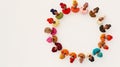 Dolls in colorful dresses and headscarves forming a heart on a white background