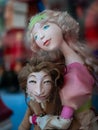 Dolls depicting fairytale heroes in a window of a Moscow Puppet Theater. The figure of a woman and a young man. Buildings opposite