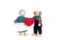 Dolls Elderly man and woman. Grandfather gives grandmother a heart a symbol of love and trust. Valentine`s day, love. On
