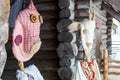 Dolls in MeteÃâ i mumming masks and costumes of pig and goat standing at log cart-house