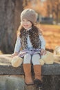 Dolly pin-up toothsome young brunette girl wearing fashion stylish gray jacket jerkin and warm hat with awesome boots clothes posi