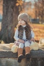 Dolly pin-up toothsome young brunette girl wearing fashion stylish gray jacket jerkin and warm hat with awesome boots clothes posi