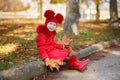 Dolly pin-up toothsome young girl wearing red blushful winter jacket and warm hat with boots fashion stylish clothes posing in aut