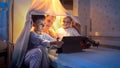 Dolly shot of family in bedroom using tablet computer. Family having time together, children with gadgets, parenting, happy Royalty Free Stock Photo