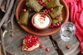 Dolma on a ceramic plate with pomegranate and chacha