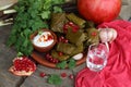 Dolma on a ceramic plate with pomegranate and chacha