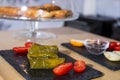 Dolma, delicious Casucasian and Turkish cuisine, vine leaves stuffed with minced meat and rice. Cookies and cheese in background Royalty Free Stock Photo