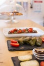 Dolma, delicious Casucasian and Turkish cuisine, vine leaves stuffed with minced meat and rice and italian bruschetta with cherry Royalty Free Stock Photo