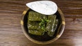 Dolma sarma or tolma stuffed grape leaves with rice, meat and white sauce cream Royalty Free Stock Photo