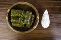 Dolma sarma or tolma stuffed grape leaves with rice, meat and white sauce cream Royalty Free Stock Photo