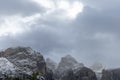 Dolomite mountains are enveloped in an overcast sky, with patches of snow accentuating the intricate patterns Royalty Free Stock Photo