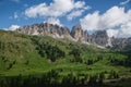 Dolomite mountains and green grassy hills at the Gardena Pass