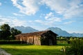 Dolomite mountains in Italy with an old vintage barn in the foreground. Tourism in the Dolomites. Royalty Free Stock Photo