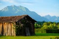 Dolomite mountains in Italy with an old vintage barn in the foreground. Tourism in the Dolomites. Royalty Free Stock Photo