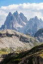 Dolomite peaks on a sunny day near Refugio Auronzo with meadow and cattle drive in the foreground Royalty Free Stock Photo