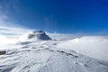 Dolomites - Cima Rosetta seen from during winter season with snowy landscape and foggy  blue sky Royalty Free Stock Photo